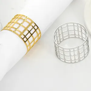 Detail of lattice hollow alloy napkin rings in gold and silver finishes for table decor