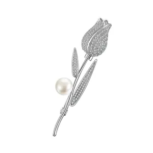 Detailed view of silver tulip brooch with micro-pave zircons and a white pearl accent