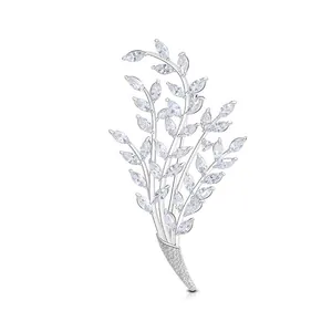 Elegant silver branch brooch with marquise-cut crystal leaves in a radiant nature-inspired design