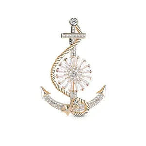 Golden nautical anchor brooch with sparkling crystals and central flower motif