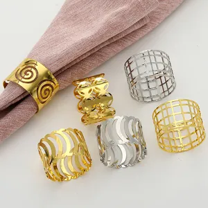 Detailed view of hollow metal napkin rings in gold and silver finish with elegant patterns