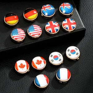 Close-up of assorted national flag cufflinks featuring Germany, USA and UK on black leather