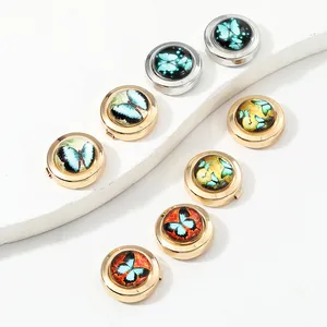 Macro shot of butterfly pattern cufflinks in gold and silver finish for dress shirts