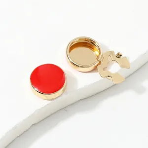 Detail view of round red enamel and gold copper cufflinks for men suit decoration