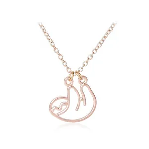 Detail of rose gold sloth necklace pendant with minimalist hollow outline design