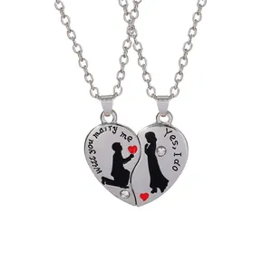 Detail of couple heart pendant with Will you marry me and Yes I do engraving