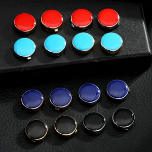 Detail of colorful enamel suit buttons with gold and silver metal edges on leather