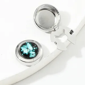 Detailed close-up of butterfly car aromatherapy diffuser with open metal clip and lid