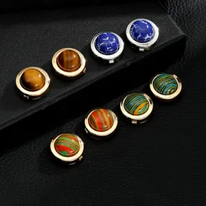 Close-up of luxury metal cufflinks with tiger eye stone and colorful marble inlays