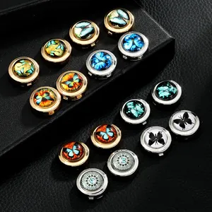 Macro view of round metal cufflinks featuring colorful butterfly patterns on black leather