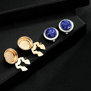 Macro detail of luxury French cufflinks showing gold finish and blue marble stone inlay