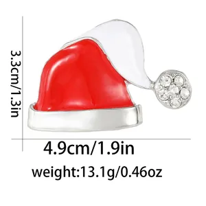 Detailed view of Santa hat brooch with dimensions 4.9cm by 3.3cm and rhinestone inlay