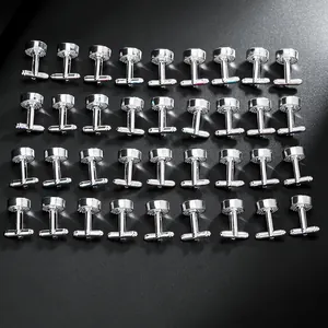 Mens silver cufflinks with striped texture in a neat array on black background