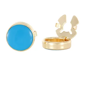 Detailed close-up of golden cufflinks with sky blue enamel finish in an open and closed view
