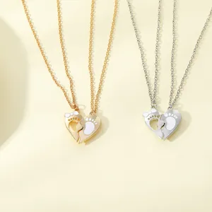 Detail showing two-piece heart pendant necklaces with footprints and bow design