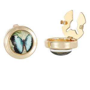 Golden butterfly cufflinks with blue patterns and a flip-open design on white background