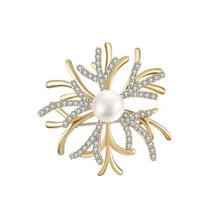 Golden coral brooch featuring a central white pearl and sparkling zircon crystal accents