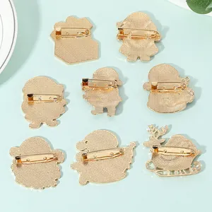 Back view of 8 gold-plated Christmas pins with secure metal clasp and textured finish
