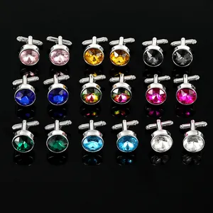 Detailed set of nine pairs of round metal cufflinks with colorful faceted crystals