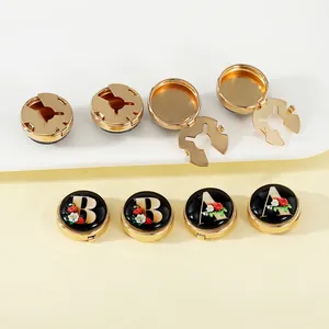 Classic A-Z initial cufflinks with floral pattern in gold frame on black glossy background