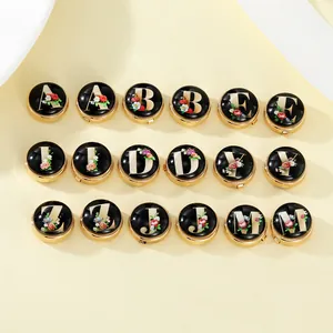 Classic A-Z gold alphabet cufflinks with intricate floral patterns and black enamel finish
