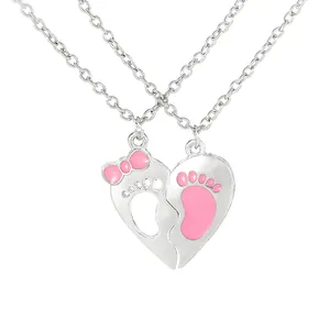 Silver heart pendant necklace set with pink footprint cutout and bow for couples