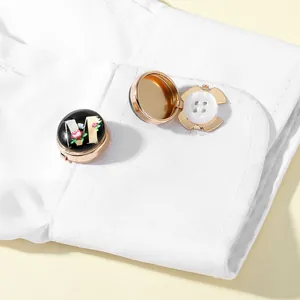 Macro detail of rose gold initial M cufflinks on a white shirt cuff with hinge view