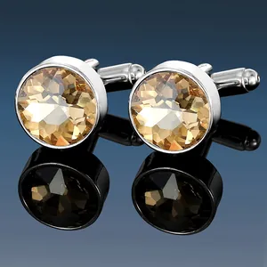 Macro shot of silver metal cufflinks featuring faceted champagne crystal inserts