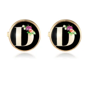 Elegant gold round cufflinks featuring black background with letter D and floral pattern