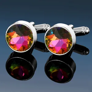 Macro shot of silver cufflinks with multi-faceted colorful crystal stones and mirror reflections