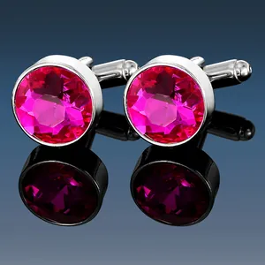 Macro shot of men's silver cufflinks featuring polished pink crystal gemstones