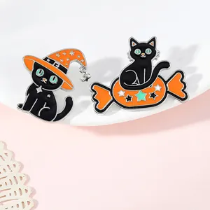 Cute Halloween enamel pins featuring a black cat with a wizard hat and sitting on candy