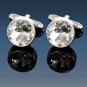 Macro shot of silver cufflinks featuring round multi-faceted clear crystal stones