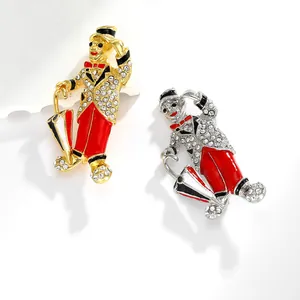 Detail of vintage clown brooches in gold and silver with red enamel and sparkling crystals