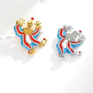 Detail view of colorful enamel clown brooches with sparkling crystals in gold and silver