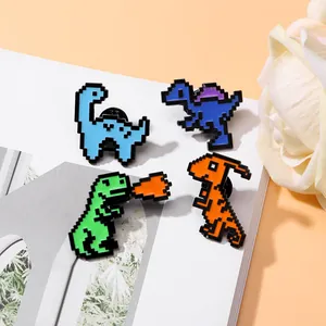 Set of four colorful pixel art dinosaur enamel pins displayed on a white card