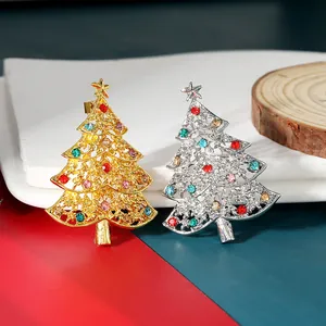 Detail of Christmas tree brooches with colorful rhinestones in gold and silver finish