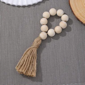 Rond de serviette fait main en perles de bois avec pompon en jute de style bohème