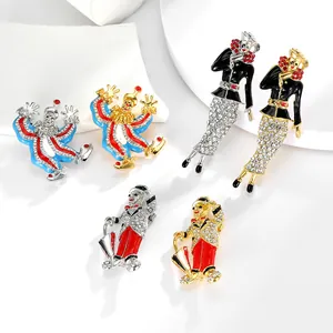 Detail of vintage clown and elegant female brooches with colorful enamel and crystals