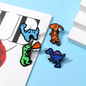 Detail showing four different pixel art dinosaur enamel pins on a blue background
