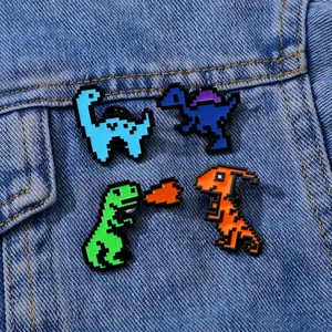 Set of four 8-bit pixel art dinosaur enamel pins on a blue denim jacket background