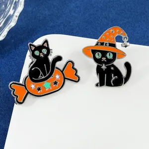 Detailed view of Halloween enamel pins featuring cute black cats with orange candy bags