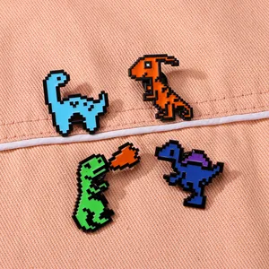 Close-up of 8-bit pixel art dinosaur enamel pins on pink fabric clothing accessory