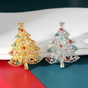Detailed macro view of gold and silver Christmas tree brooches with colorful rhinestones