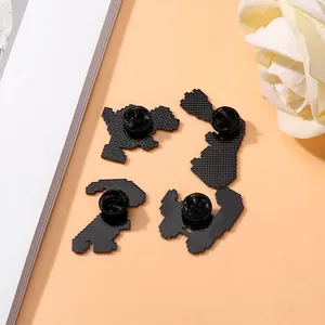 Back view of 4 cartoon dinosaur enamel pins showing rubber clutch and grid texture base