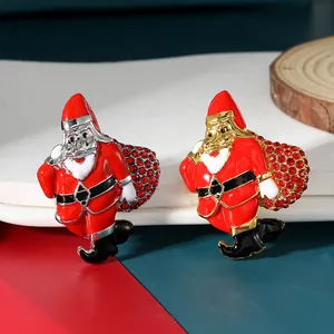 Close-up of Santa Claus brooches with colorful rhinestones and gold-silver metal plating