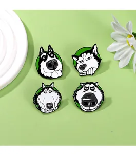 Close-up of four husky enamel pins with funny expressions on a green background