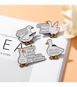 Close-up of four cute white duck enamel pins with funny internet meme designs