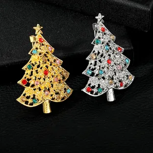 Detail of Christmas tree brooches with colorful rhinestones in gold and silver finish