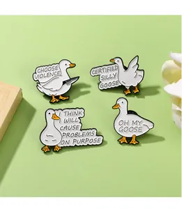 Close-up of four funny duck enamel pins with humorous slogans on a wooden background